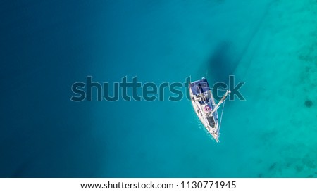 Sailing boat anchoring in Croatia bay, aerial view. Active life style, water transportation and marine sport.