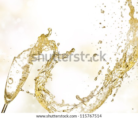 Champagne wine splashing out of glass