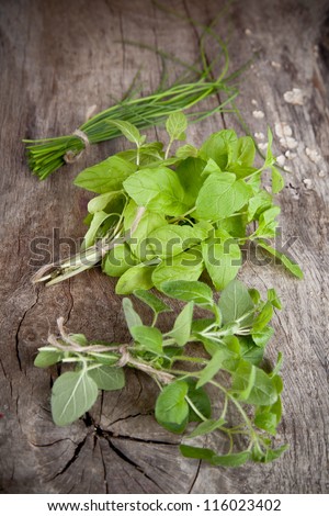 Fresh bunches of herbs on wooden table