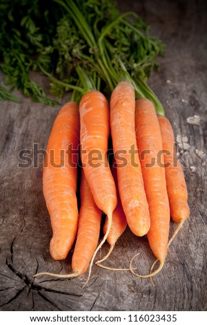 Fresh carrots on wooden table