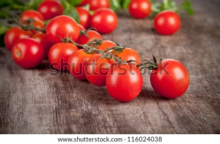 Cherry tomatoes on wooden table, low depth of focus