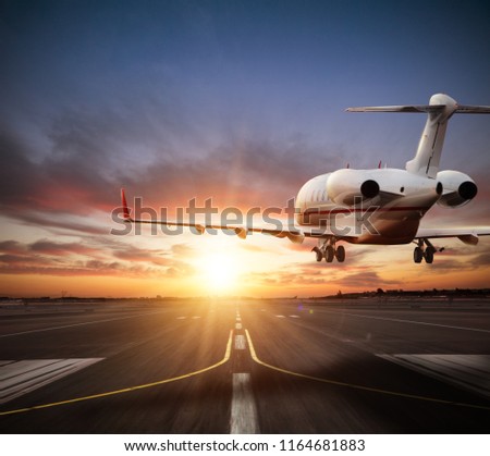 Private jet plane landing on runway in beautiful sunset light. Modern and fastest mode of transportation, business and succesfull style of life.