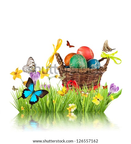 Easter basket full of colored eggs in grass, isolated on white background