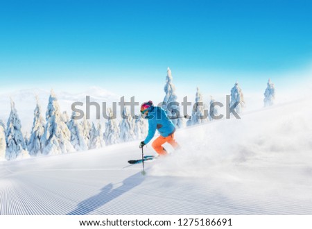 Young man skiing on piste. Winter sport and recreation in alpen mountain.