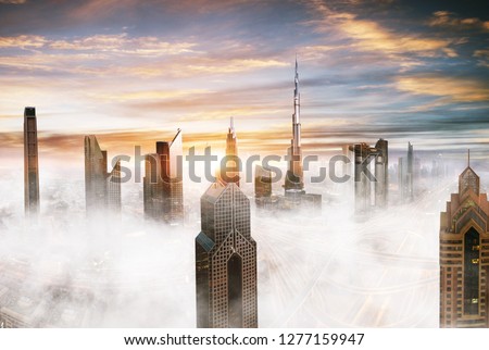 Dubai sunset panoramic view of downtown with low clouds. Dubai is super modern city of UAE, cosmopolitan megalopolis. Very high resolution image
