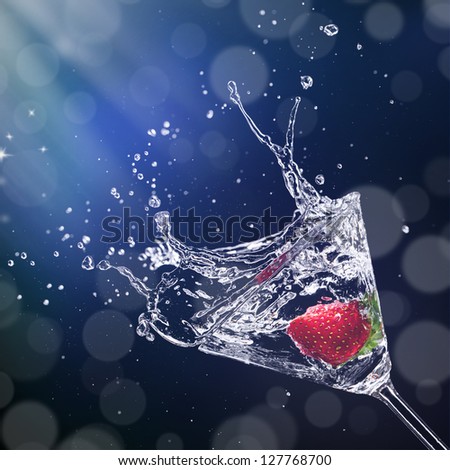 Martini drink splashing out of glass