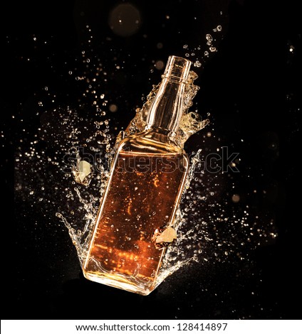 Concept Of Liquor Splashing Around Bottle, Isolated On Black Background