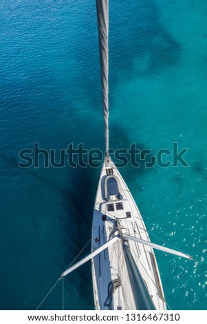 Top view of sailing boat anchored in the shallows. Summer sport and recreation activities.