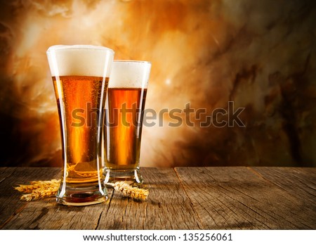 Glasses Of Beer On Wooden Table
