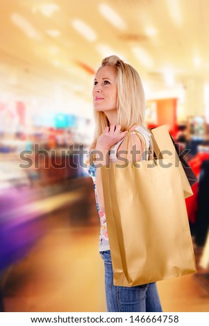 Concept of shopping with blond girl carrying bags
