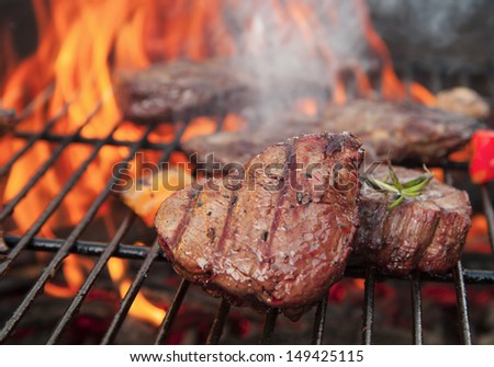 Delicious beef steakes on grill