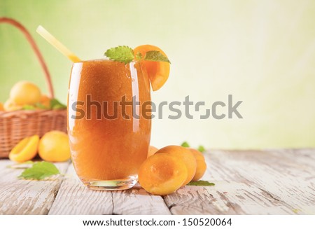 Fresh apricot drink on wood