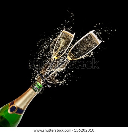 Glasses of champagne with bottle, isolated on black background