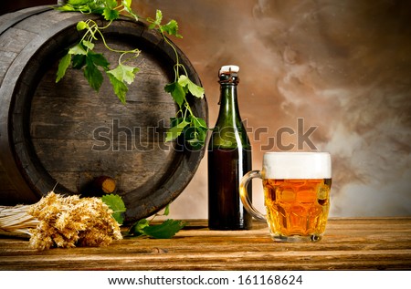 Beer keg with glass of beer and blur background