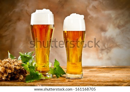 Beer keg with glasses of beer and blur background