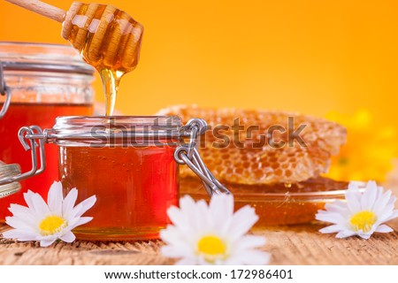 Still life of honey on wooden table