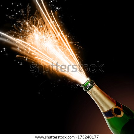 Champagne bottle with blasting fire, isolated on black background