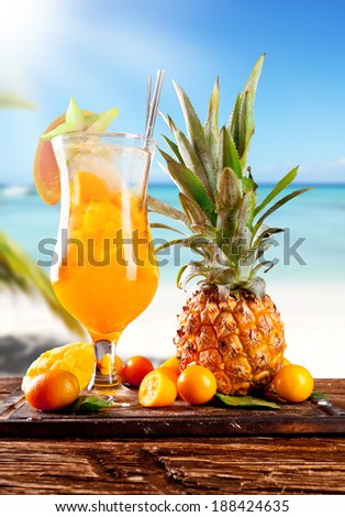 Fresh summer orange drink, blur beach on background