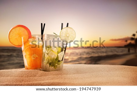 Exotic summer drinks , blur sandy beach on background