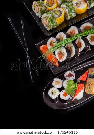 Various kind of sushi food served on black background