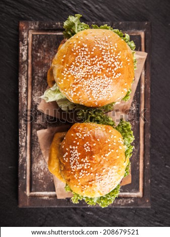 Delicious hamburgers served on black stone, shot from upper view