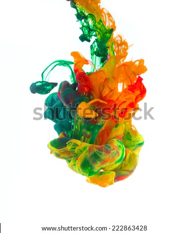 Studio shot of colored ink in water, isolated on white background
