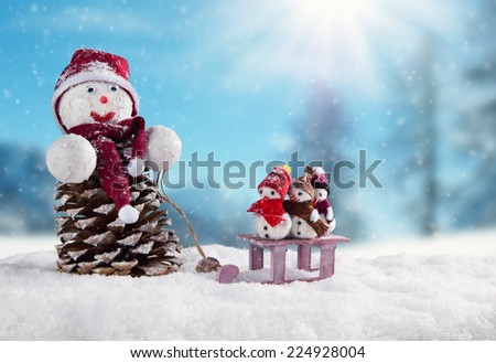 Winter holiday happy snow men with blur landscape on background. Concept of hapiness and family life