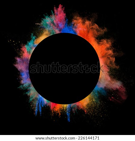 Freeze motion of colored dust explosion in circle shape, isolated on black background