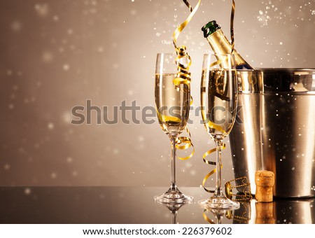Glasses of champagne with ribbons and bubbles around. Concept of celebration