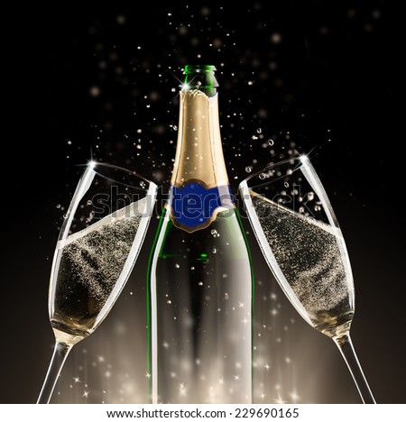 Celebration theme. Glasses and bottle of champagne with bubbles, isolated on black background