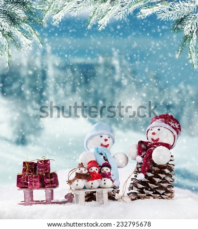 Winter holiday happy snow men with blur landscape on background. Concept of love and togetherness