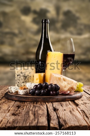 Various kind of cheese with red wine in cellar