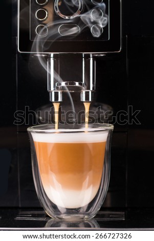 Detail of coffee machine making cappuccino