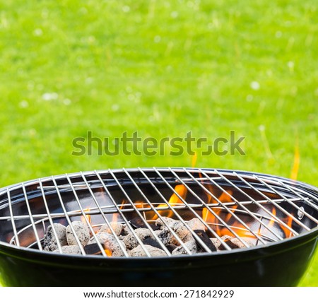 Empty grill with fire on garden