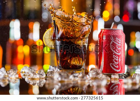 Prague, CZECH REPUBLIC - MAY 11, 2015 : Can of Coca-Cola with glass splash on ice cubes. Coca-Cola is the one of the worlds favourite soft drinks.