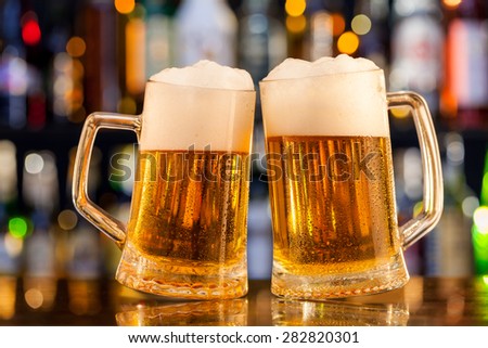 Jugs of beer placed on bar counter with copy space
