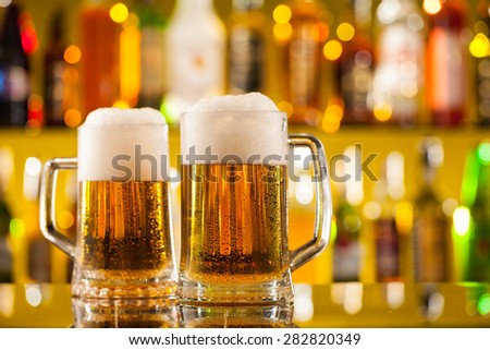Jugs of beer placed on bar counter with copy space