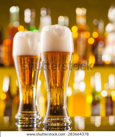 Jugs of beer placed on bar counter with free space for text