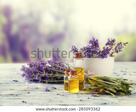 Harvested lavender flowers on wooden planks, blur landscape on background