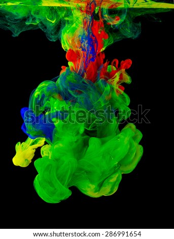 Studio shot of colored ink in water on black background
