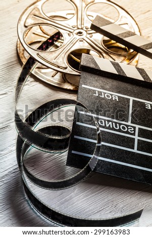 Film camera chalkboard and roll on wooden table