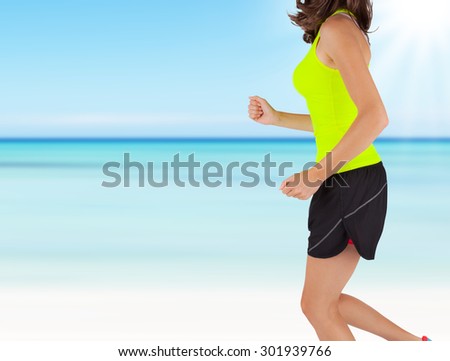 Close-up of woman runner. Detail on body and arms with blur motion beach background. Concept of body training and healthy lifestyle.
