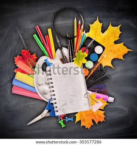 School accessories placed on black board. Concept of education and start of new school year
