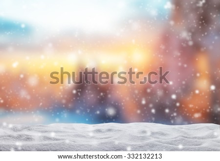Winter background with pile of snow and blur evening landscape. Copyspace for text