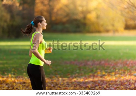 Female fitness model training outside and listening to music. Sport and healthy lifestyle