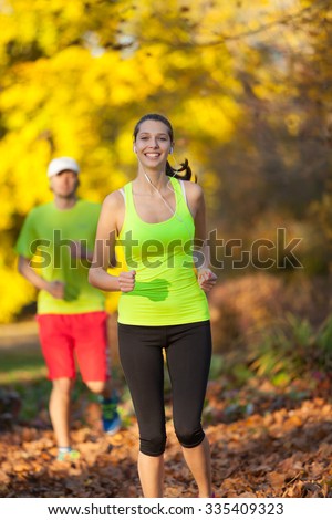 Young couple running in autumn season. Concept of fitness exercise and bidy training