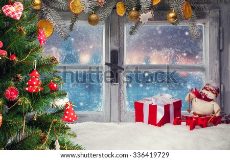 Atmospheric Christmas window sill decoration with beautiful sunset view.Christmas tree on foreground