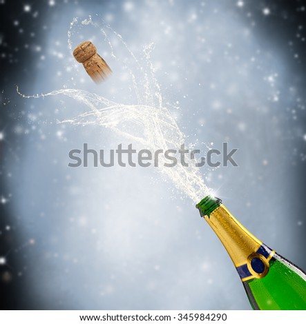 Celebration theme with splashing champagne, isolated on black background