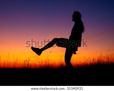 Young man silhouette in sunset