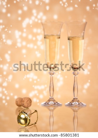 Two glasses of champagne on sparkle background, focused on cork